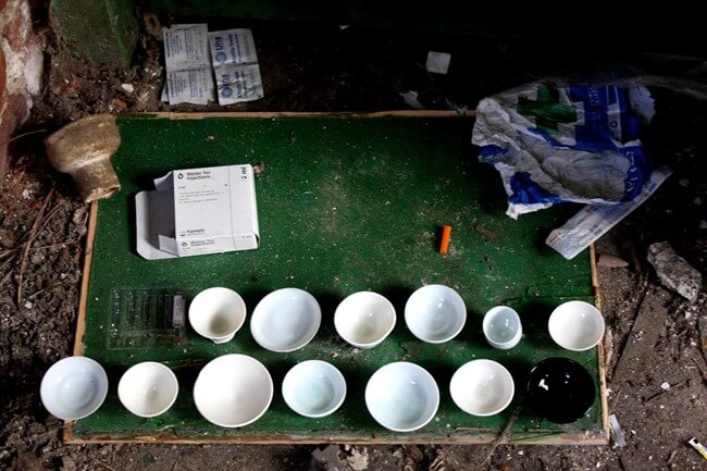 Abandoned Factory used as a drug den, Sheffield, January 2009. Thrown porcelain vessels as part of an installation, recorded by photography.